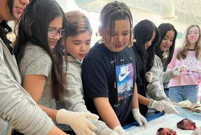  sixth graders wearing medical gloves